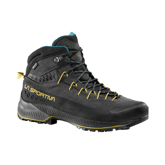 Black hiking boot with yellow accents on a white background